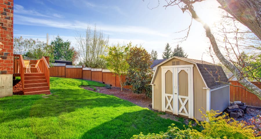 Fenced backyard with storage shed in Prescott